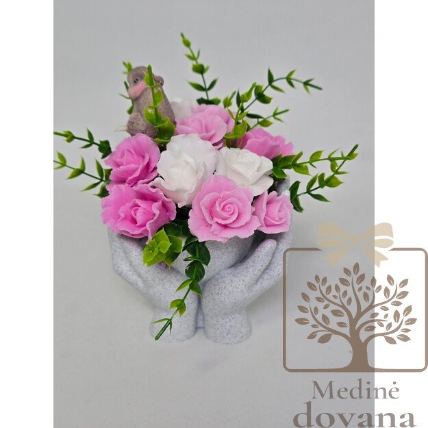 Muilo gėlės rankų vazoje su paukšteliu