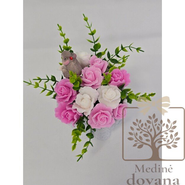 Muilo gėlės rankų vazoje su paukšteliu