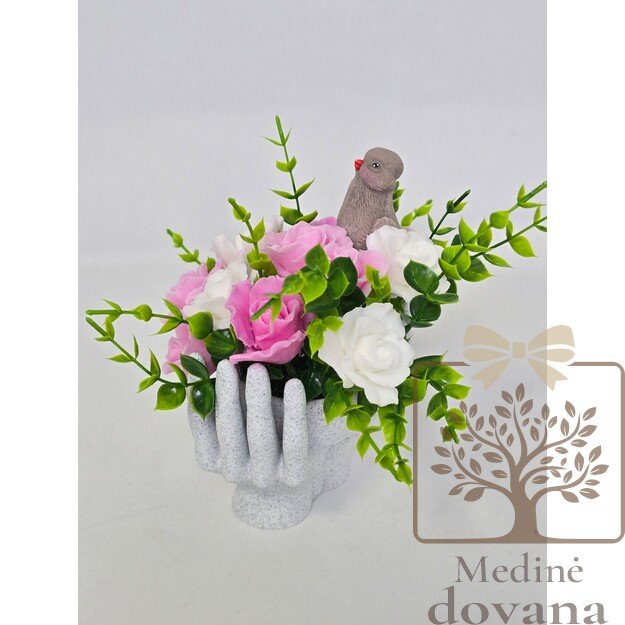 Muilo gėlės rankų vazoje su paukšteliu