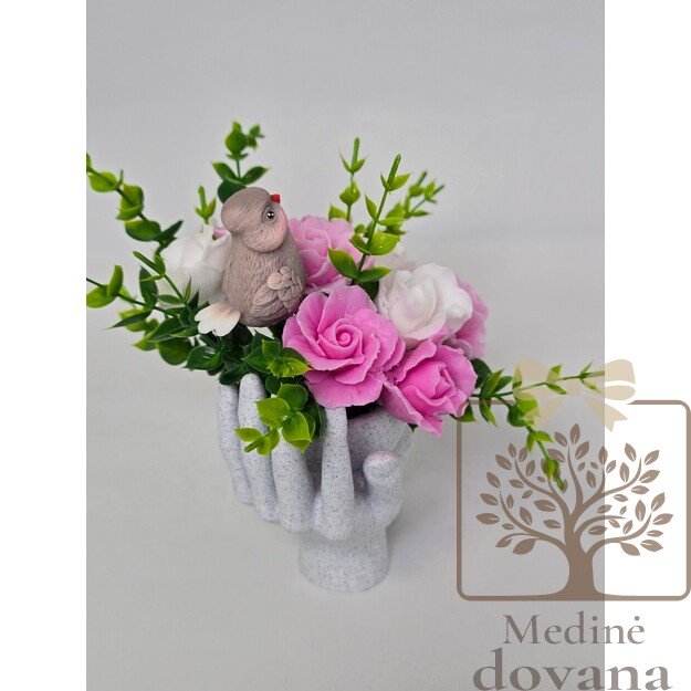 Muilo gėlės rankų vazoje su paukšteliu